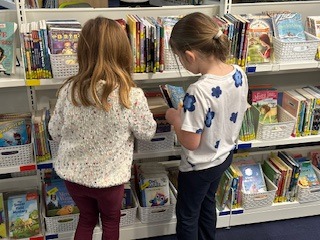 students looking at books on the new shelves