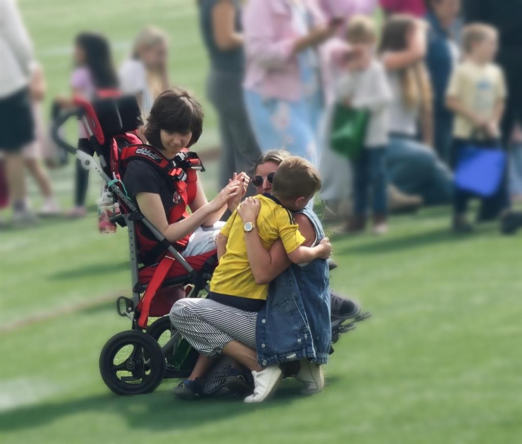 staff member hugging her son while having her senior meet 