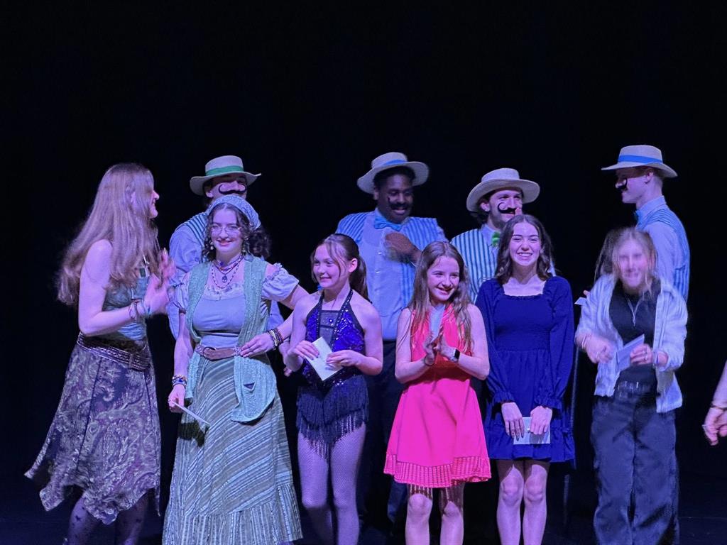 A group standing on stage at Greely's Got Talent