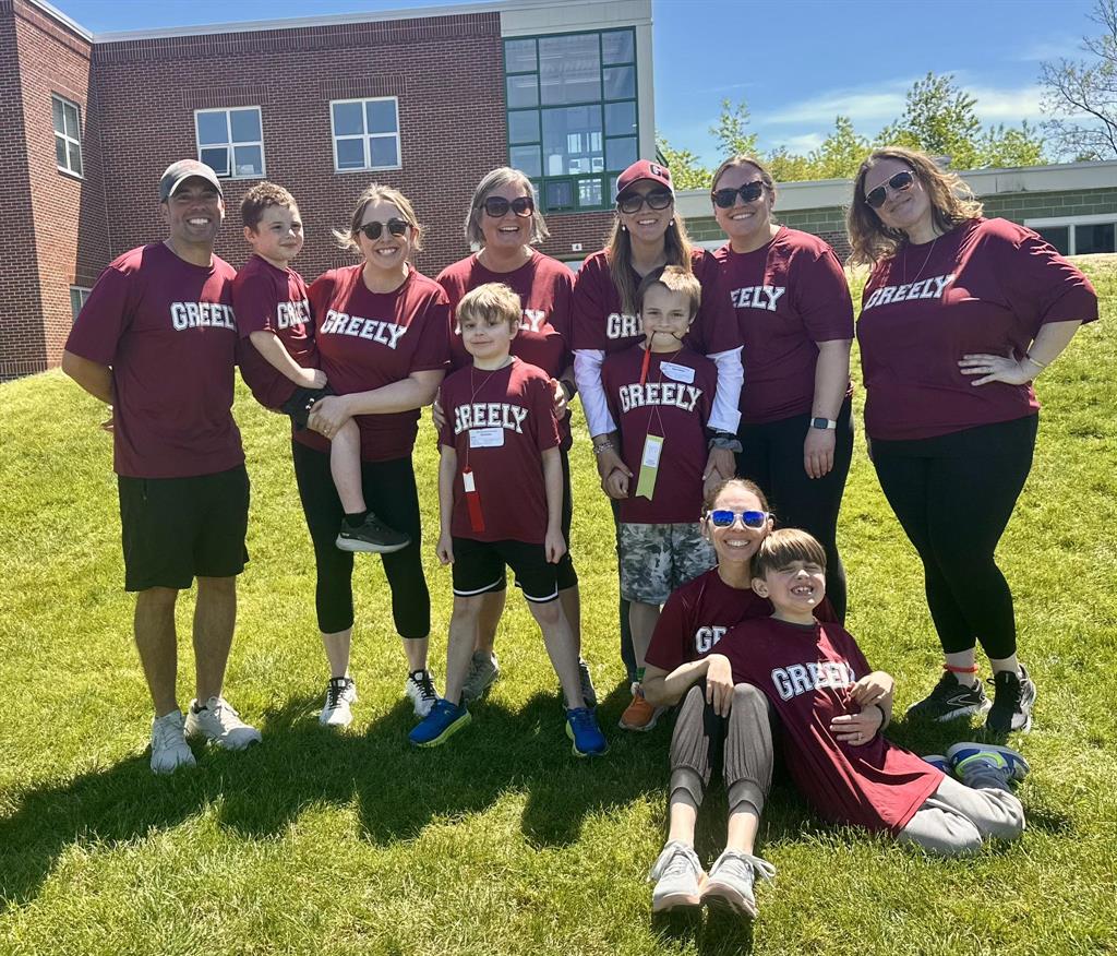 MIW staff and students photo ahead of Special Olympics track